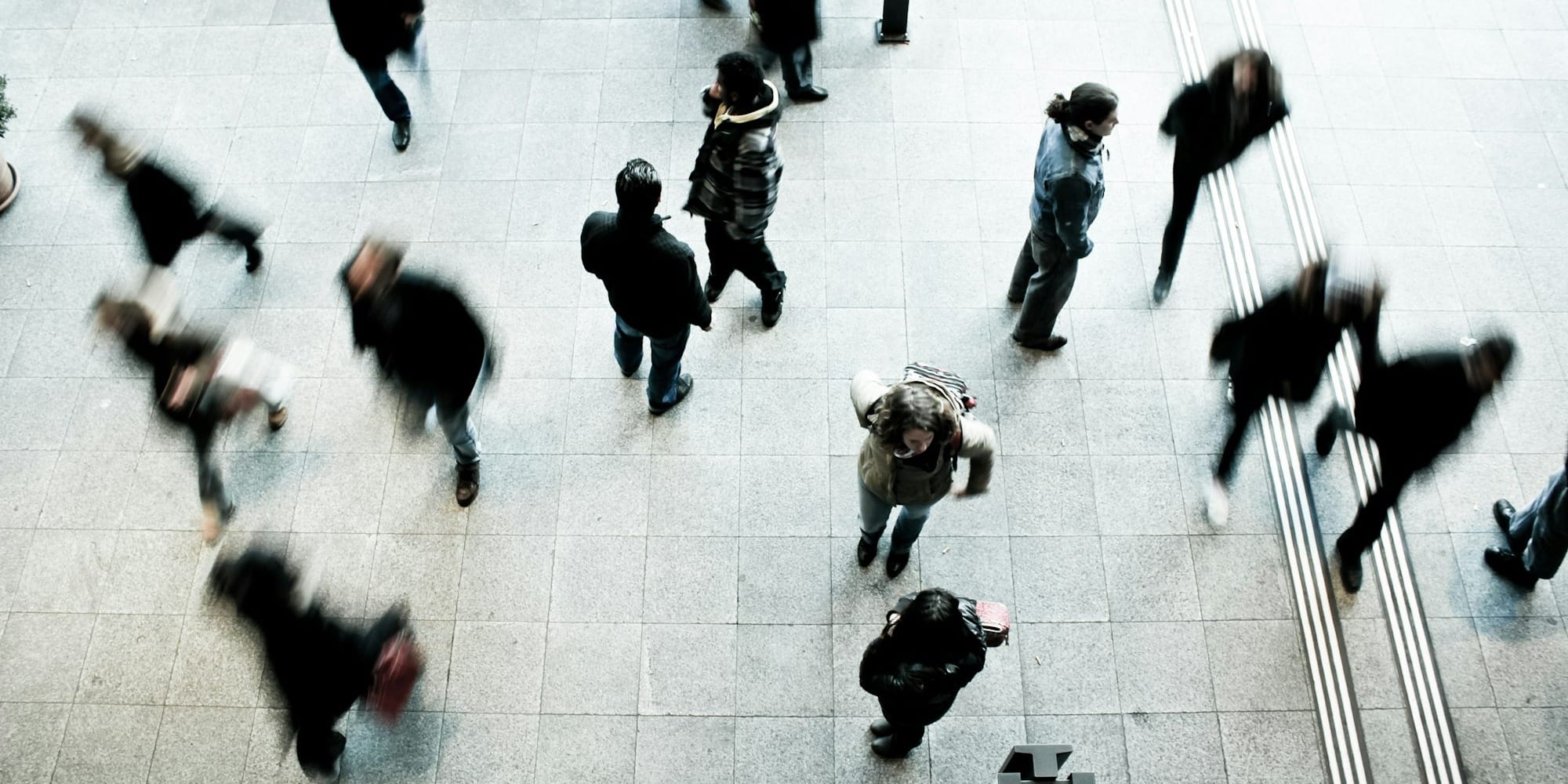 people walking on grey concrete floor during daytime