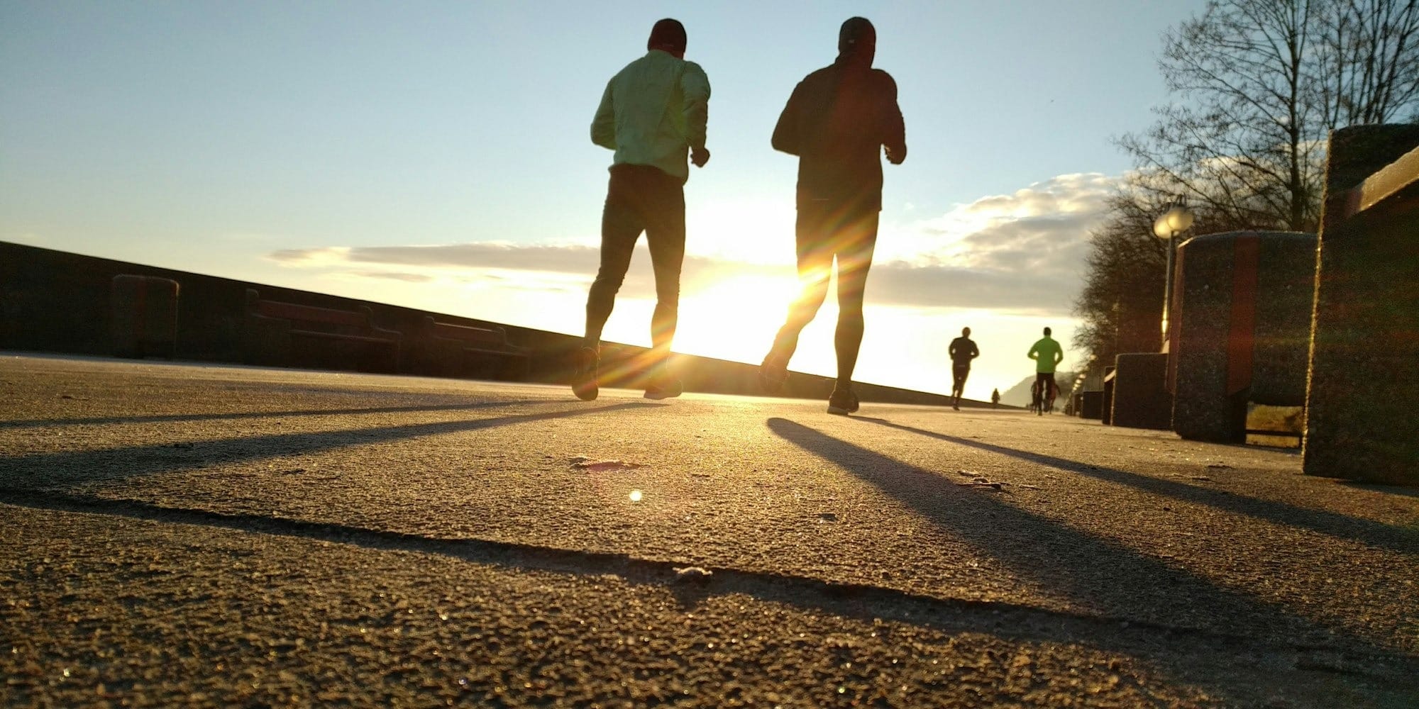 two men running at park