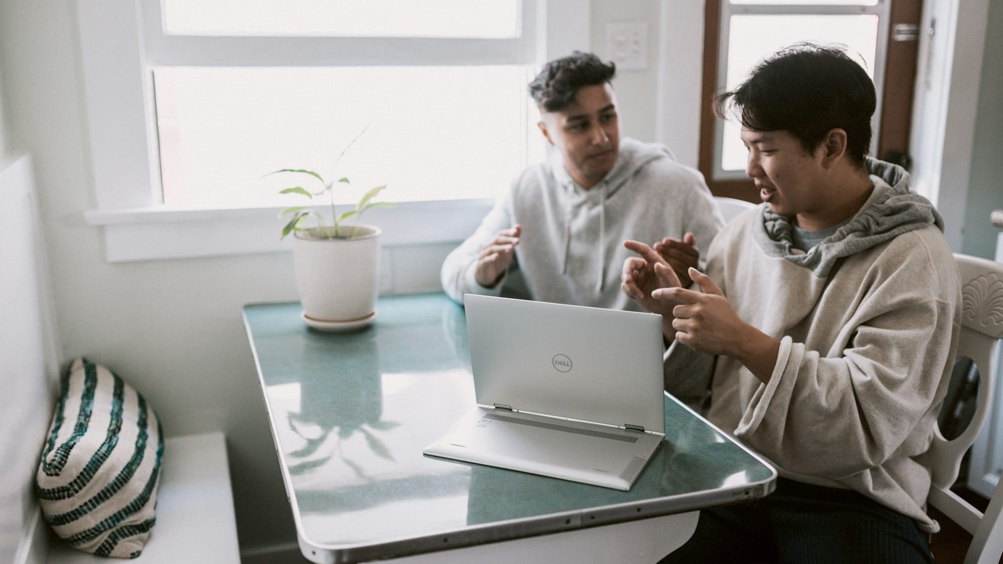 man in white dress shirt using silver laptop